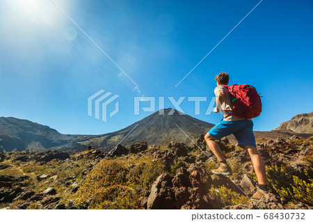 Tongariro National Park Alpine crossing hike trail man tramper tramping hiking in volcanic landscape. Near Taupo, North Island. Adventure travel traveler walking trek with bag backpacking 68430732