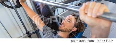 Fitness gym man doing bench press banner crop Fitness gym man doing bench press banner crop 68431006