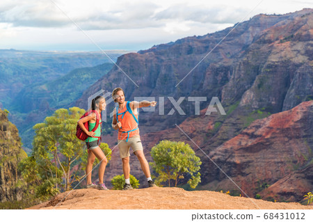 Hiking couple looking at view in mountain nature Hiking couple looking at view in mountain nature 68431012
