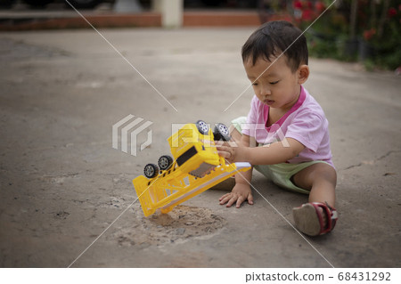 little boy plays with his toy car with a very 68431292