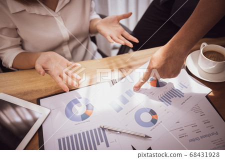 Sale person meeting brainstorming and discussing analyzing income chart Sale person meeting brainstorming and discussing analyzing income chart 68431928