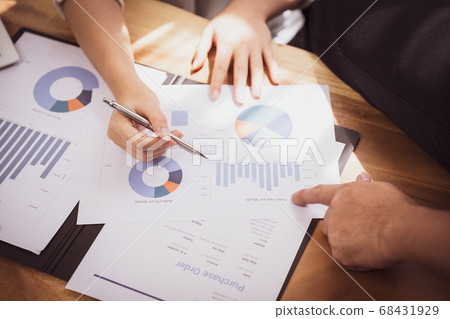 Sale person meeting brainstorming and discussing analyzing income chart Sale person meeting brainstorming and discussing analyzing income chart 68431929