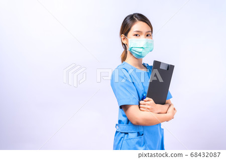 Portrait of young Asian nurse wearing surgical mask isolated on white background Portrait of young Asian nurse wearing surgical mask isolated on white background 68432087