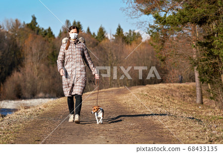 Young woman in warm jacket, wearing virus face Young woman in warm jacket, wearing virus face 68433135