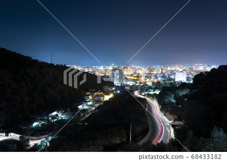 The light trails n the road leading to the Albanian night city 68433182