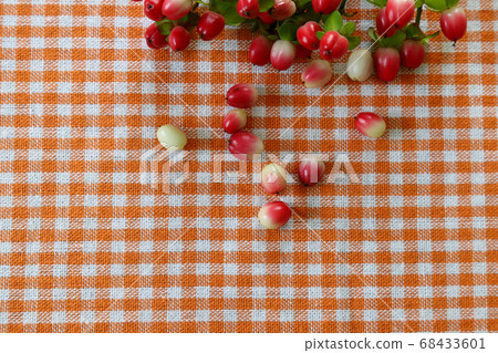 Hypericum fruits placed on a checkered tablecloth Hypericum fruits placed on a checkered tablecloth 68433601