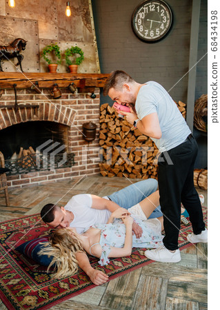 lovers on carpet, friend with camera make photos. lovers on carpet, friend with camera make photos. 68434198