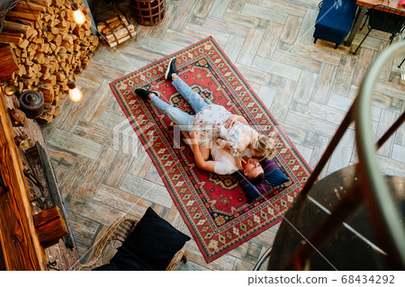 view top. couple lying on floor on carpet. view top. couple lying on floor on carpet. 68434292