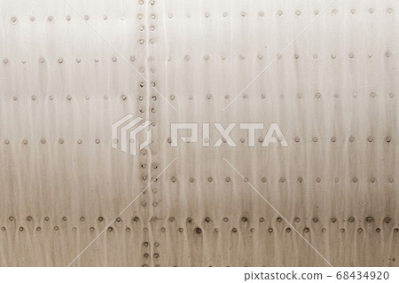 Old silver metal surface of the aircraft fuselage with rivets 68434920