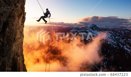 Epic Adventurous Extreme Sport Composite of Rock Climbing Man Rappelling from a Cliff Epic Adventurous Extreme Sport Composite of Rock Climbing Man Rappelling from a Cliff 68437223