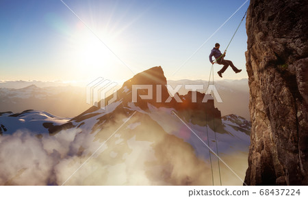 Epic Adventurous Extreme Sport Composite of Rock Climbing Man Rappelling from a Cliff Epic Adventurous Extreme Sport Composite of Rock Climbing Man Rappelling from a Cliff 68437224