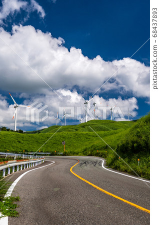 Wind power turns around in summer blue sky and white clouds landscape 68437893