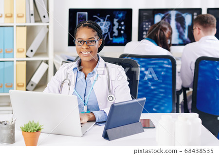 Smiling Black female doctor Smiling Black female doctor 68438535