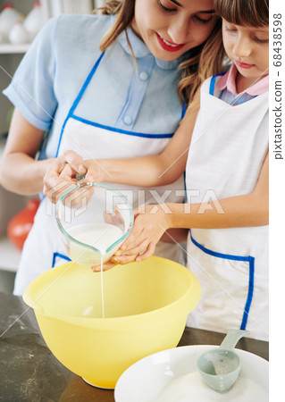 Family making pancake dough Family making pancake dough 68438598