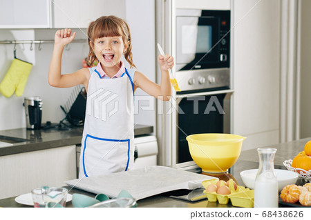 Happy girl baking cookies 68438626