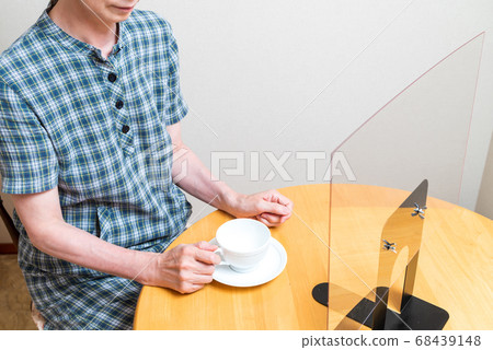 Splash infection prevention panel. Middle-aged woman is drinking tea Splash infection prevention panel. Middle-aged woman is drinking tea 68439148