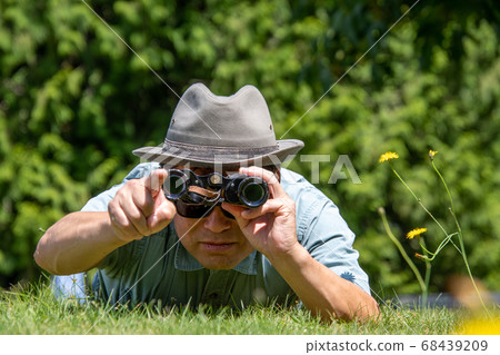 Standing hungry and looking through binoculars Front Vancouver British Columbia Canada Standing hungry and looking through binoculars Front Vancouver British Columbia Canada 68439209