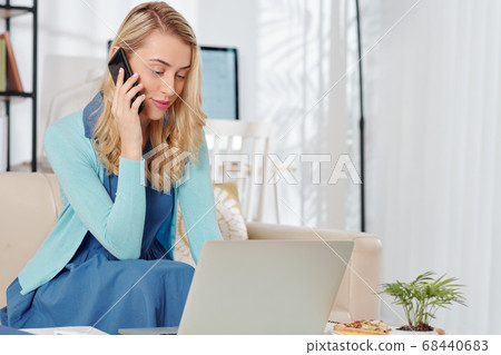 Businesswoman working from home Businesswoman working from home 68440683