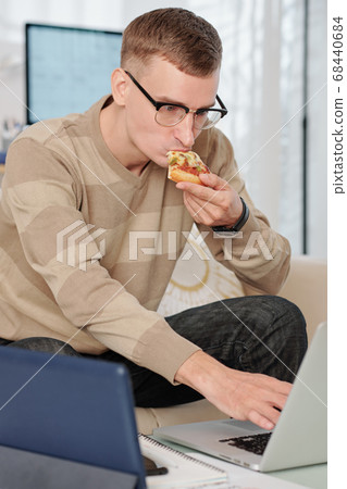 Student eating pizza Student eating pizza 68440684