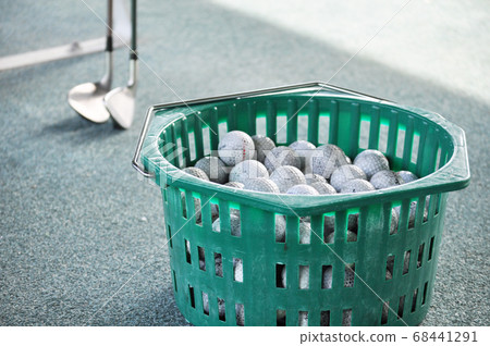 Golf balls and clubs in baskets 68441291