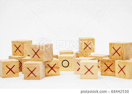 One O wooden block in the group of X wooden block on white background for idea concept design 68442530