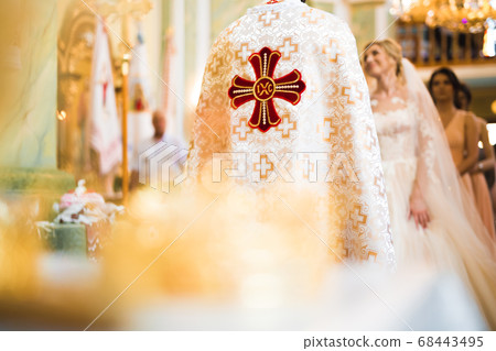 Wedding couple bide and groom get married in a church Wedding couple bide and groom get married in a church 68443495