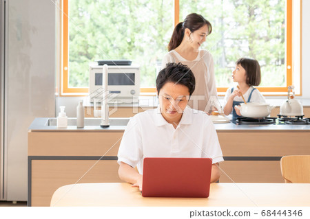 Man and family teleworking at home Man and family teleworking at home 68444346