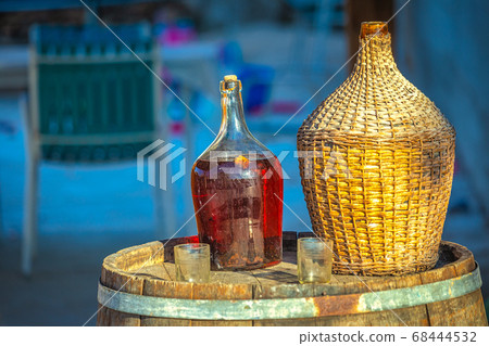 Red wine in a glass barrel and glasses. Red wine in a glass barrel and glasses. 68444532
