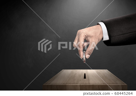 Businessman's hand giving donate charity to donation box 68445264