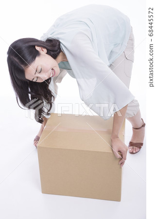 Woman with heavy luggage Woman with heavy luggage 68445572