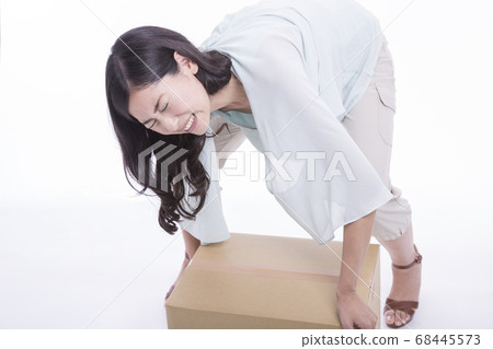 Woman with heavy luggage Woman with heavy luggage 68445573