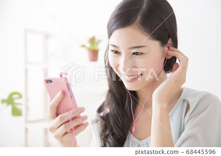 A woman listening to music A woman listening to music 68445596