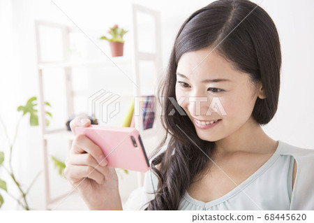 觀看智能手機的婦女 觀看智能手機的婦女 68445620
