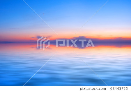 Sunset sky panorama with young moon above water surface Sunset sky panorama with young moon above water surface 68445735
