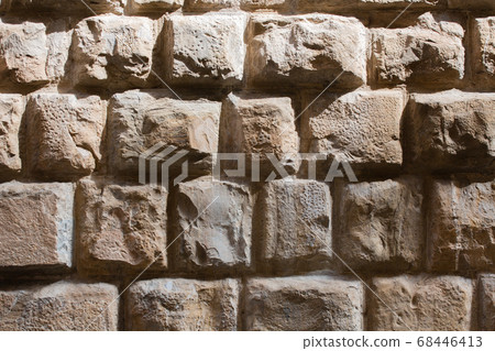 Old brick wall in sunligh. Grunge brown masonry or brickwork. Close up shot. Abstract background or texture 68446413