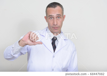 Portrait of mature handsome man doctor with gray hair Portrait of mature handsome man doctor with gray hair 68447082