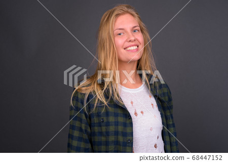 Face of happy young beautiful hipster woman with blond hair smiling 68447152