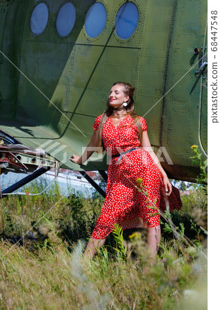 Young attractive woman in a red pin up style dress 68447548