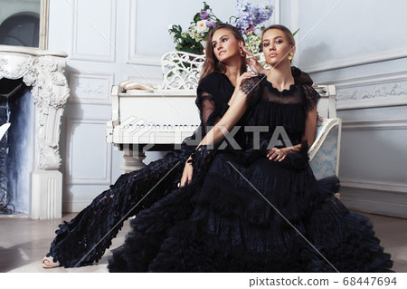 two young pretty lady in black lace fashion style dress posing in rich interior of royal hotel room, luxury lifestyle people concept 68447694