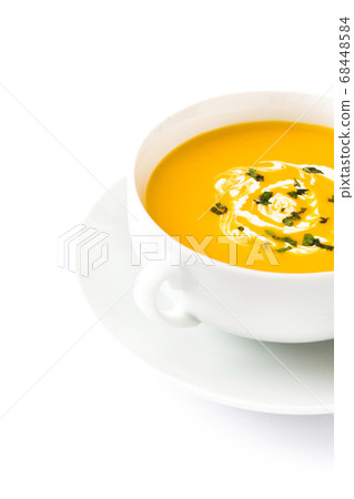 Pumpkin soup in white bowl isolated on white background 68448584