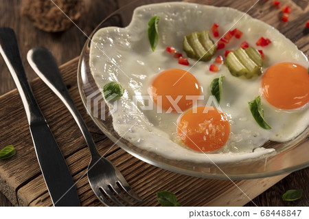 Fried eggs sunny side up healthy breakfast, traditional nutritious meal,top view Fried eggs sunny side up healthy breakfast, traditional nutritious meal,top view 68448847