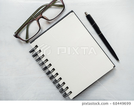 Blank notepad page, pen and glasses. Greeting card Blank notepad page, pen and glasses. Greeting card 68449699
