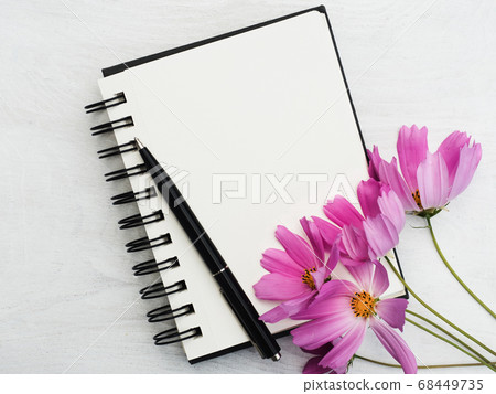 Blank notepad page and a beautiful flower Blank notepad page and a beautiful flower 68449735