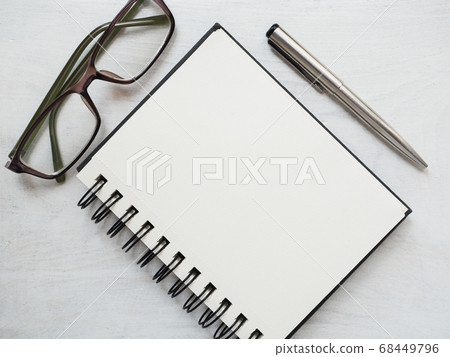 Blank notepad page, pen and glasses. Greeting card 68449796