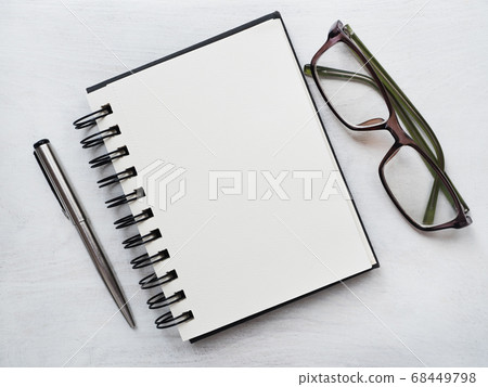Blank notepad page, pen and glasses. Greeting card 68449798