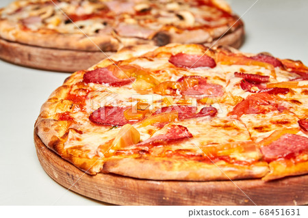 Pizza with salami, bell pepper, tomatoes and 68451631