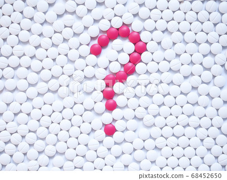 Question mark formed by unique pink pills among white ones background. Creative medicine for health/medical problem, drug information services, medication error and pharmacy concept. Question mark formed by unique pink pills among white ones background. Creative medicine for health/medical problem, drug information services, medication error and pharmacy concept. 68452650