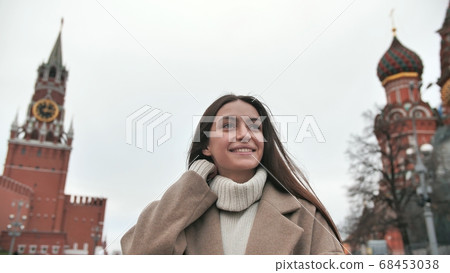 Girl tourist walks the streets Russia admire the architecture around. Women study Moscow sights. Girl tourist walks the streets Russia admire the architecture around. Women study Moscow sights. 68453038