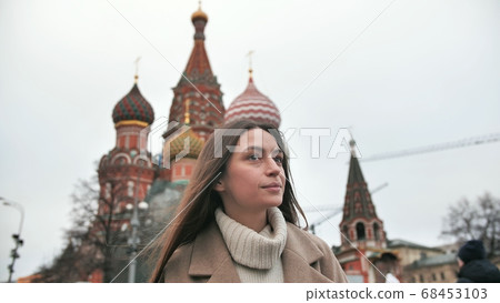 Girl tourist walks the streets Russia admire the architecture around. Women study Moscow sights. Girl tourist walks the streets Russia admire the architecture around. Women study Moscow sights. 68453103