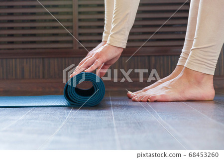 Beautiful girl getting ready for yoga indoors in Beautiful girl getting ready for yoga indoors in 68453260
